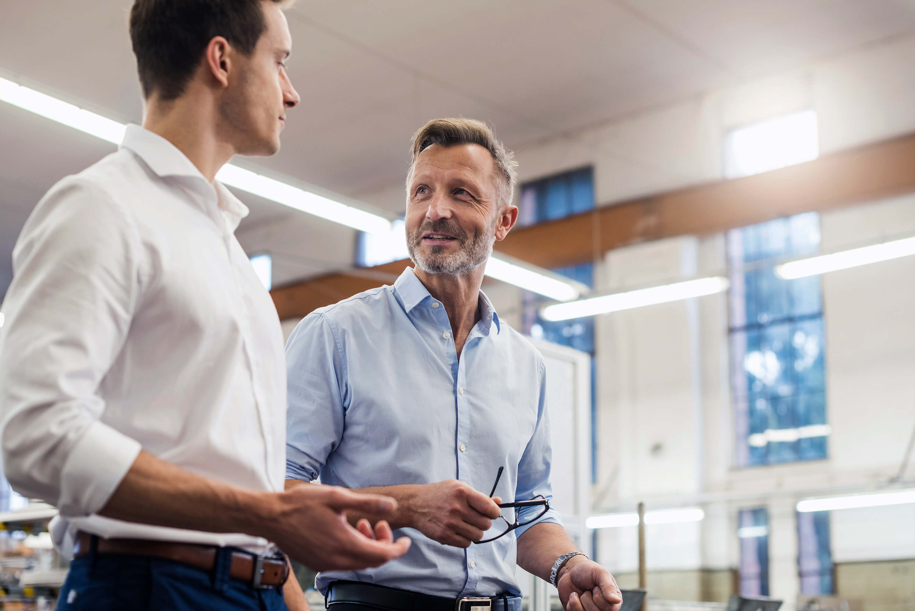 Two men in business attire talking